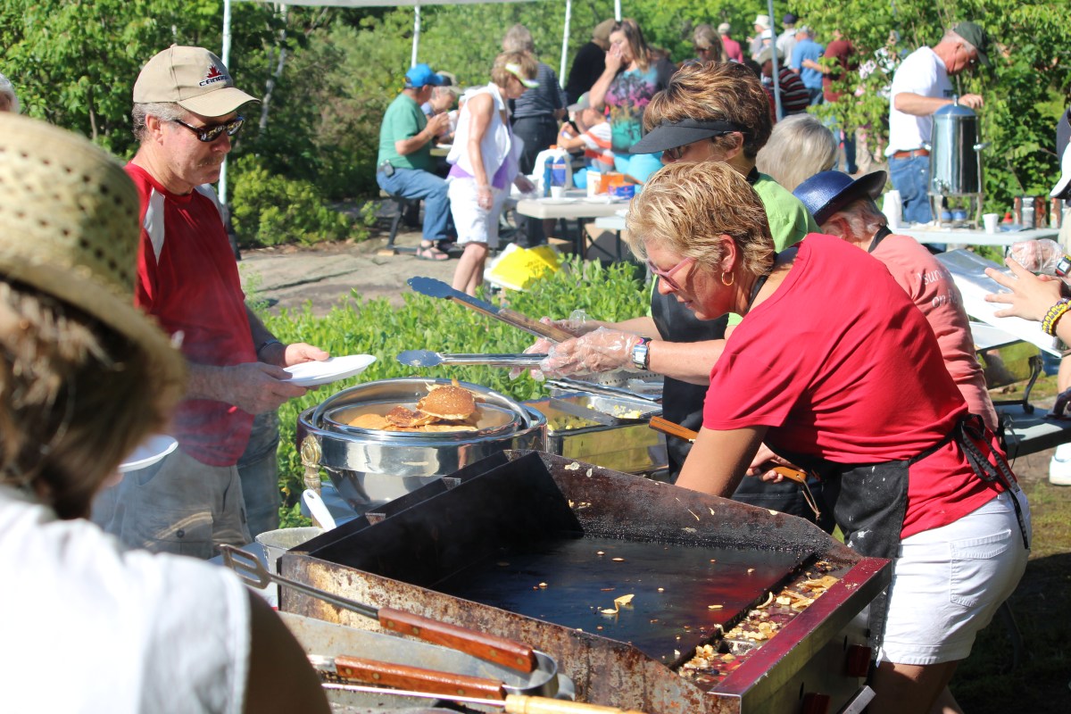 The Island Breakfast cooking team prepares to feed a new group