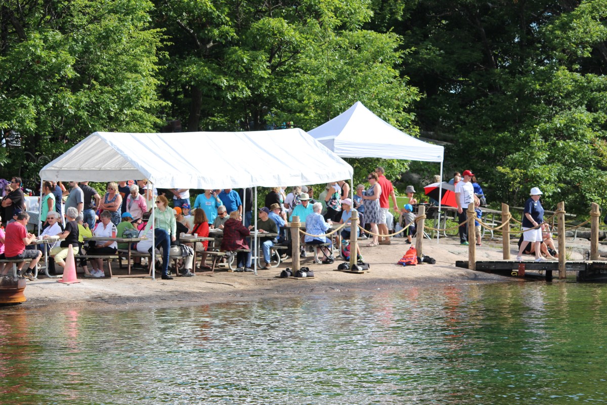People enjoying breakfast on Refugee Island, Brockville, during Island Breakfast